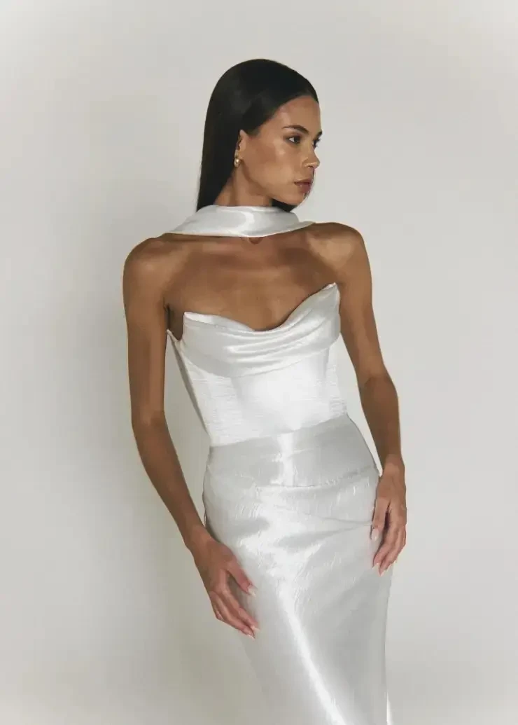 Model is wearing a sleek mermaid bridal dress with a bridal scarf