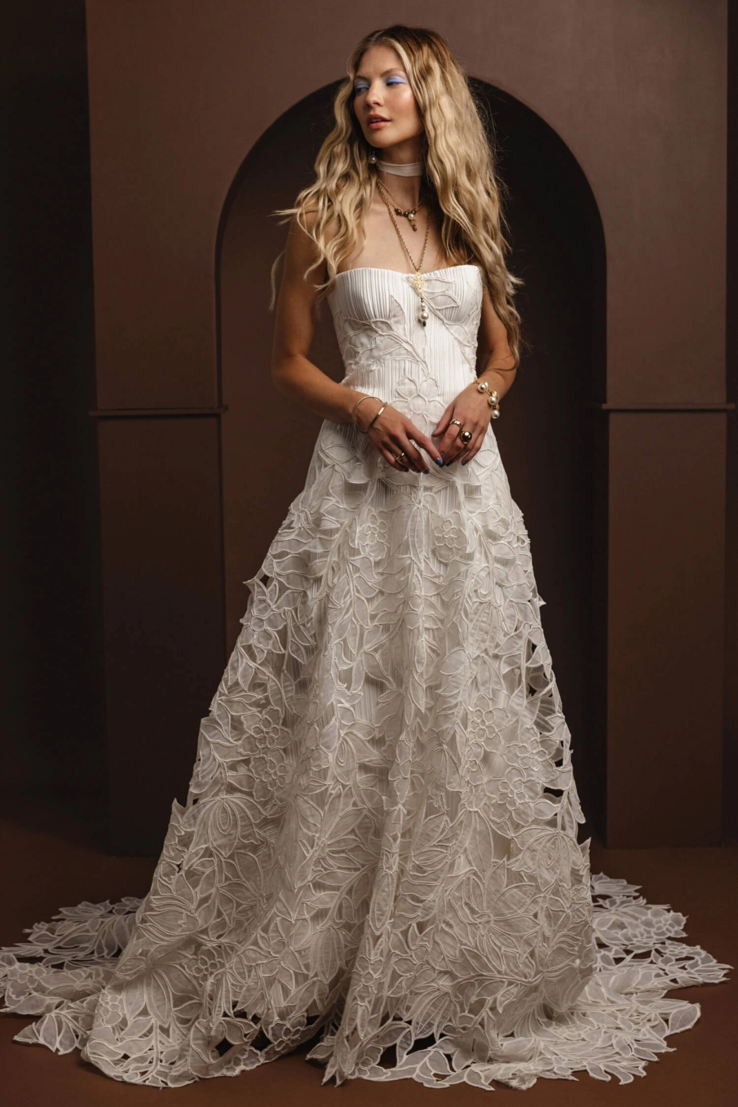 model is wearing a strapless fitted bridal dress