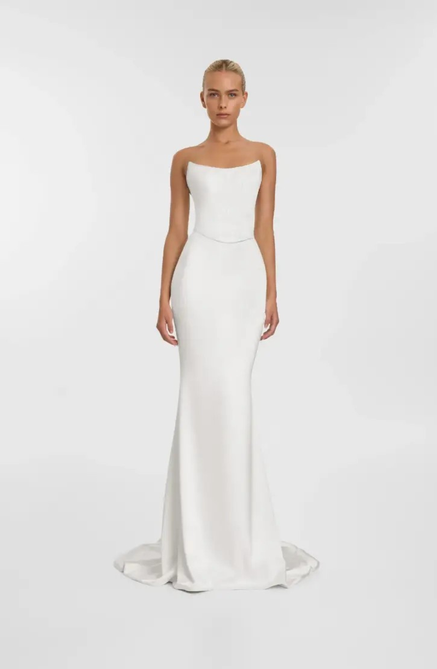 Model is wearing an off the shoulder fit and flare wedding dress 