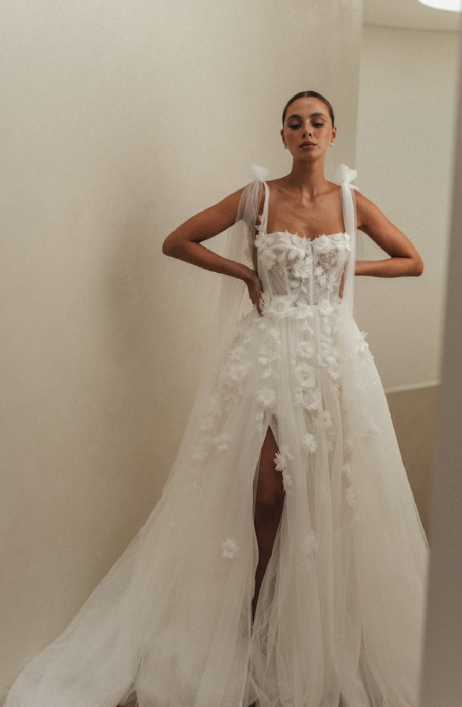 Model is wearing a tulle wedding dress by alena leena