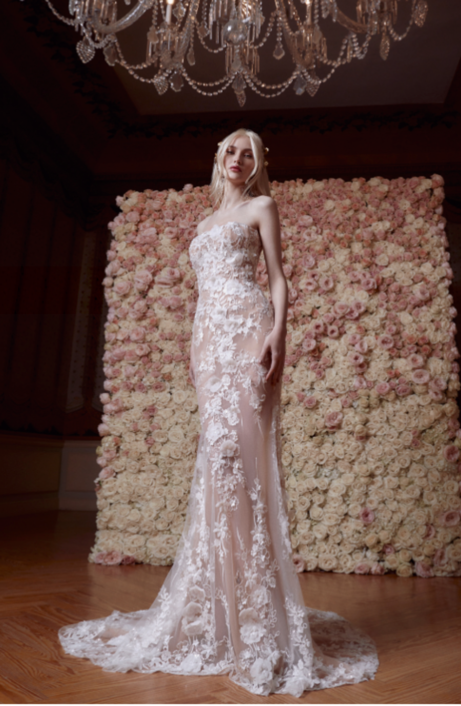 Model is wearing a mermaid strapless wedding gown with 3D floral lace 